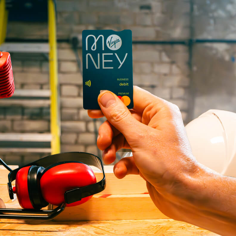 hand holding virgin money debit card