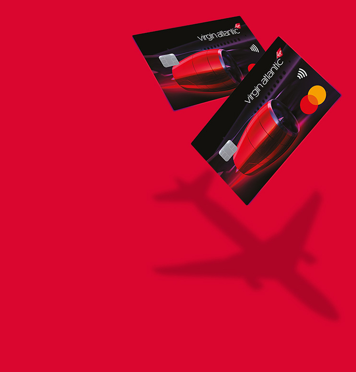 An image of two cards on a red background producing a shadow of an aeroplane 