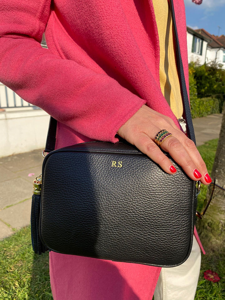 Rachel with a black leather Mila & Eve bag.