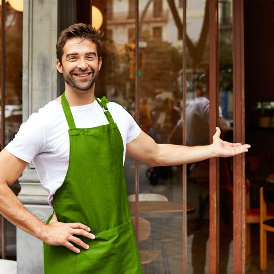 business owner in a green apron