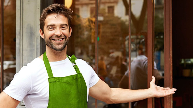 business owner in a green apron