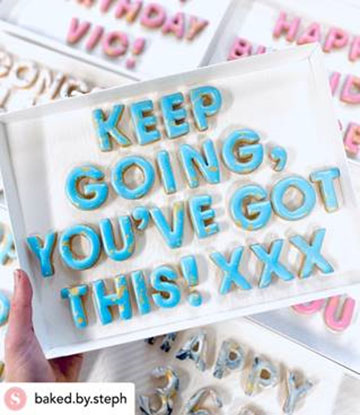 Letter shaped biscuits arranged to form a message by 'Baked by Steph'. Message: 'Keep going you've got this! xxx'.