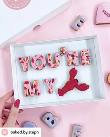 Letter shaped biscuits arranged to form a message by 'Baked by Steph'. Message: 'You're my lobster'.