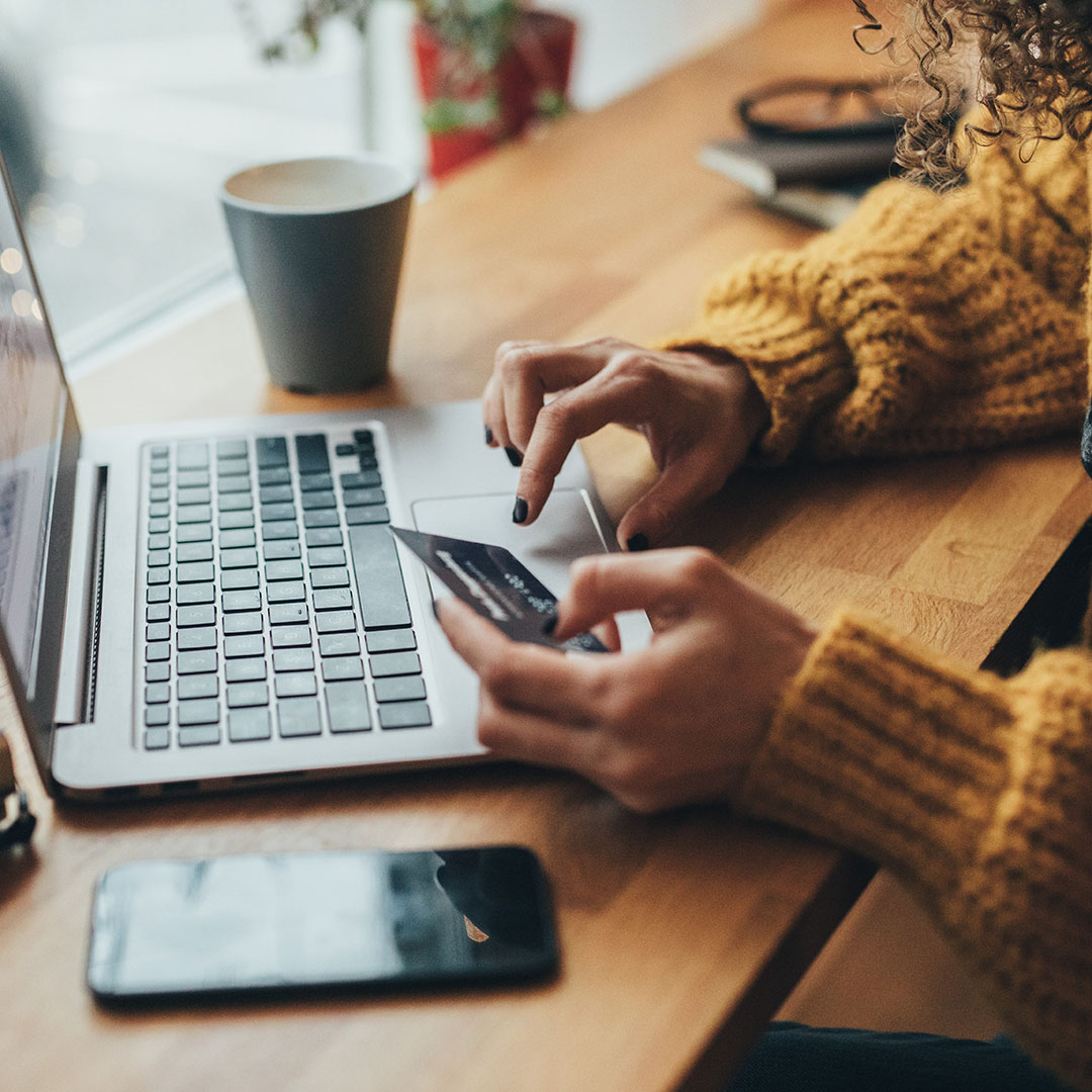 Woman entering her card details online.