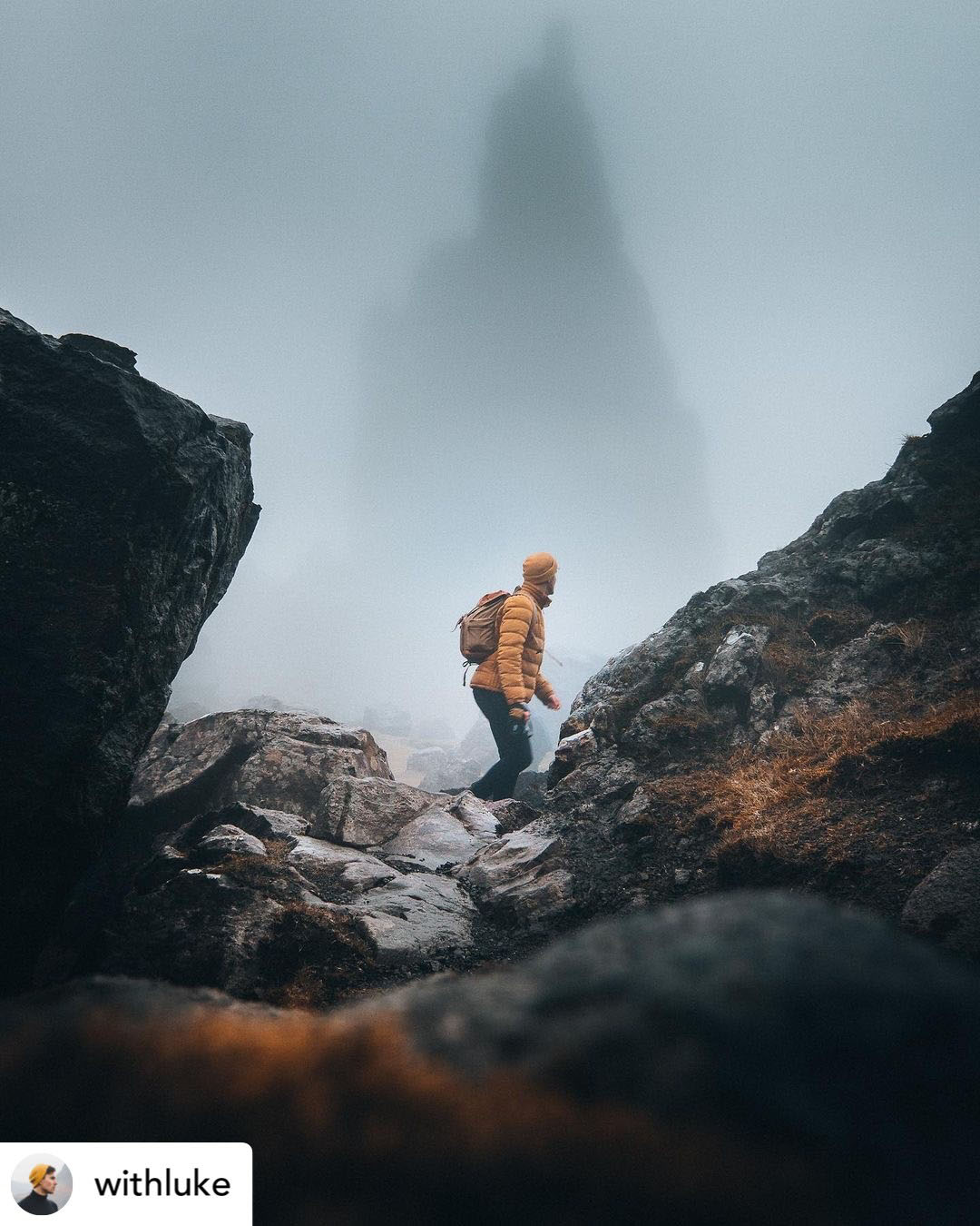 Adventure Luke hiking a dark rocky mountain in the mist. Credit: With Luke.
