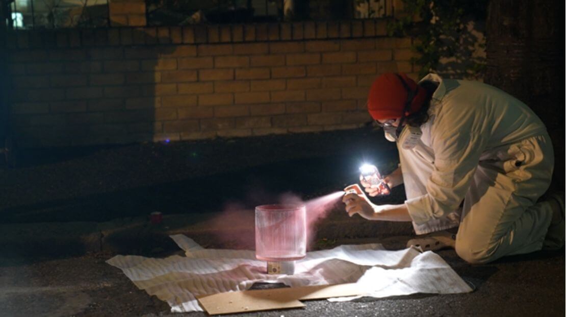 Cullen adding the red spray paint to the glass