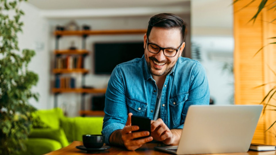 Happy person seated behind a computer