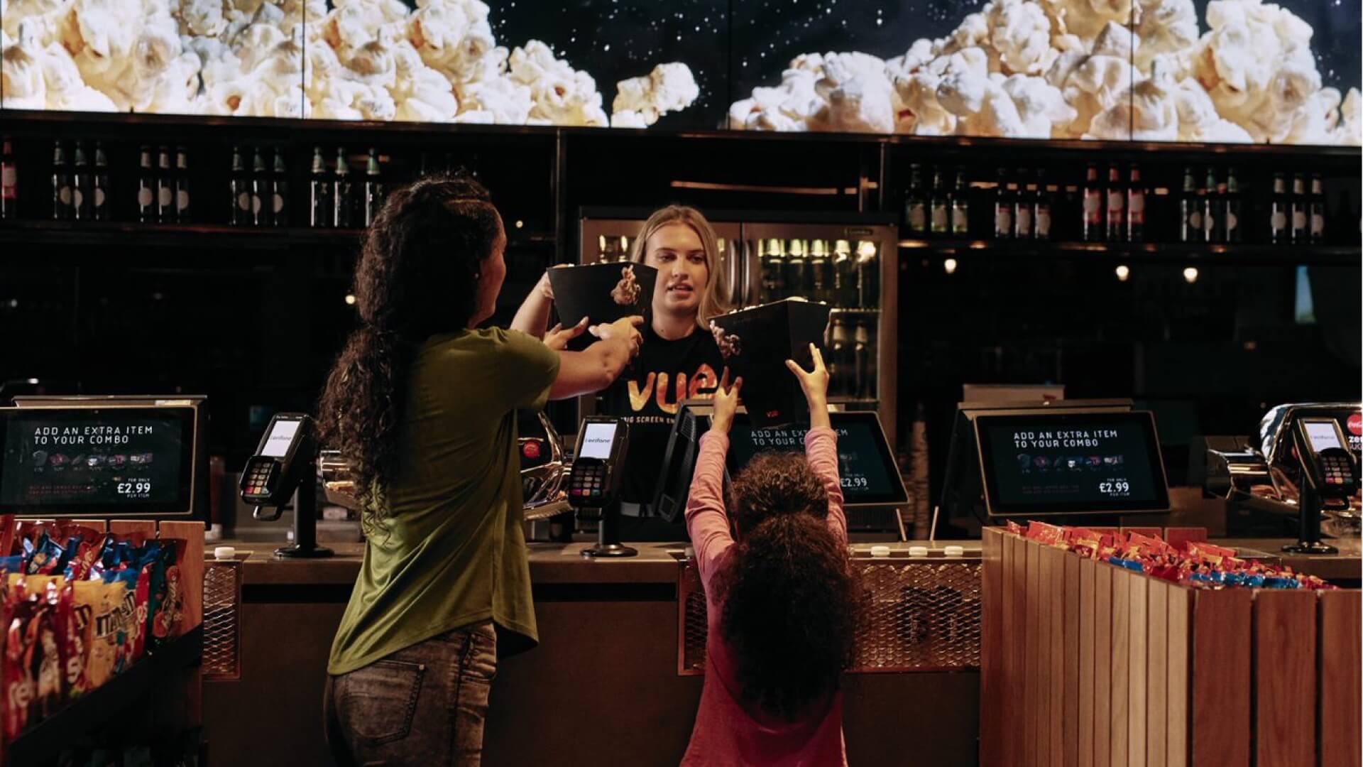 customers paying for popcorn at a cinema