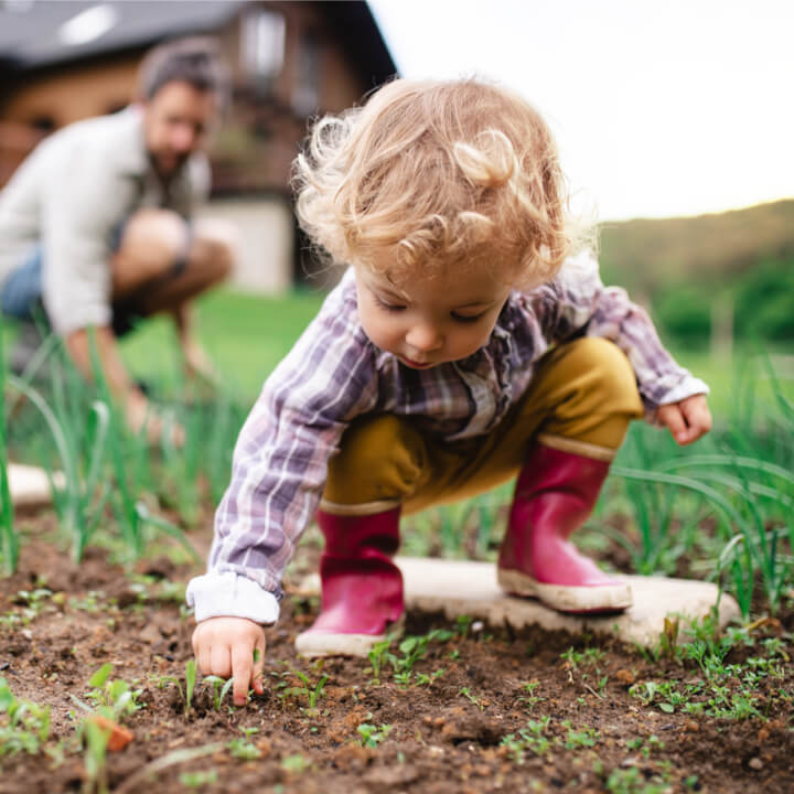 toddler playing in garden