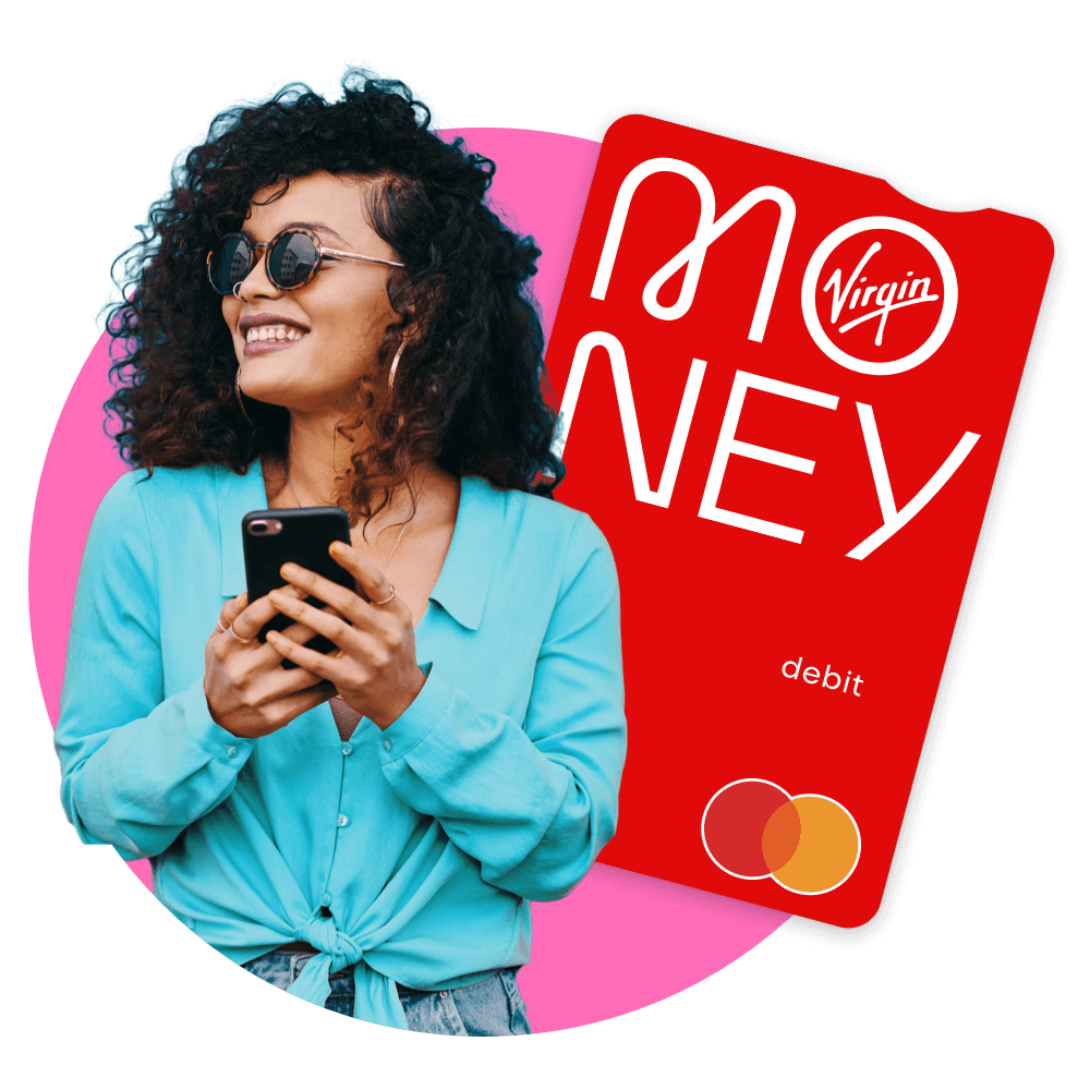 Woman wearing sunglasses in a blue shirt with a phone in her hands, grinning off to the left in the distance in front of a Virgin Money debit card