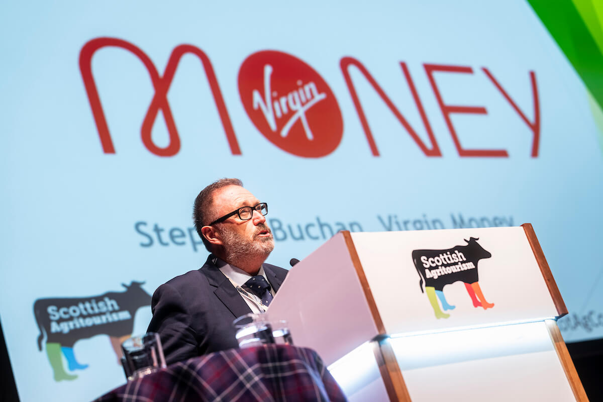 Two men smiling in barn