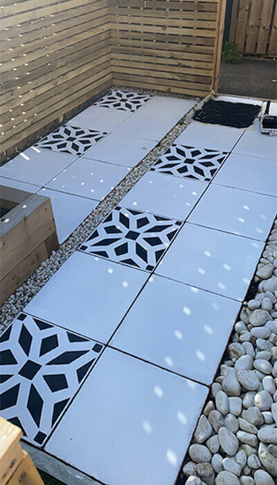 White garden slabs with a black stencil design