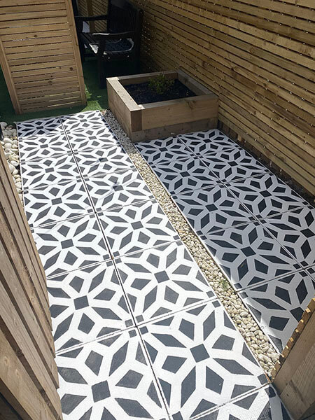 Patio tiles with a stensil design applied