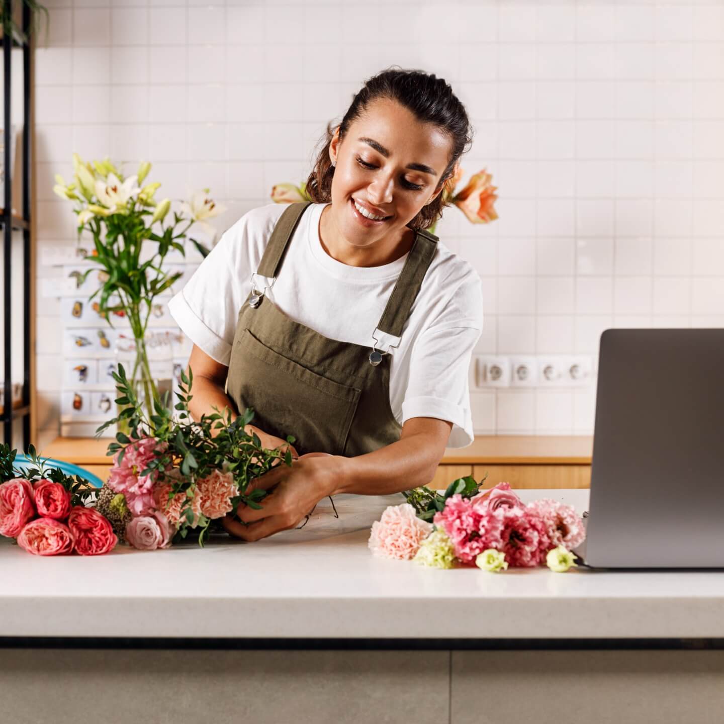 Person holding flowers whilst smiling