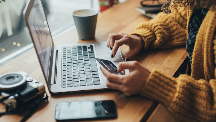 Woman entering her card details online.