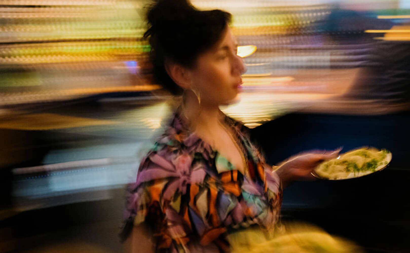 woman carrying two plates of food